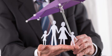 Concept of family insurance with umbrella protecting a family